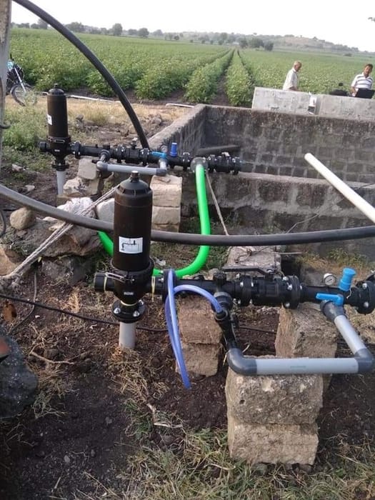 Drip filter setup beside potato field